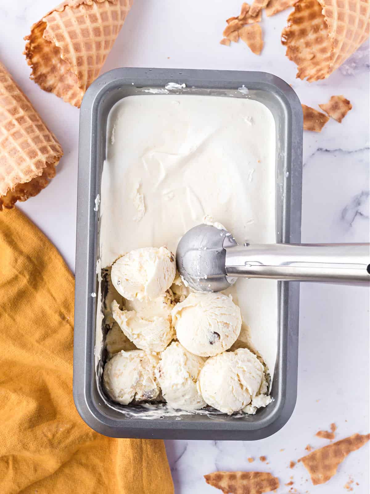 Ice cream scoop scooping cookie dough ice cream.