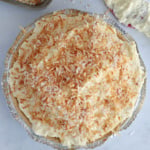 Coconut cream pie and a red spatula covered with coconut cream.