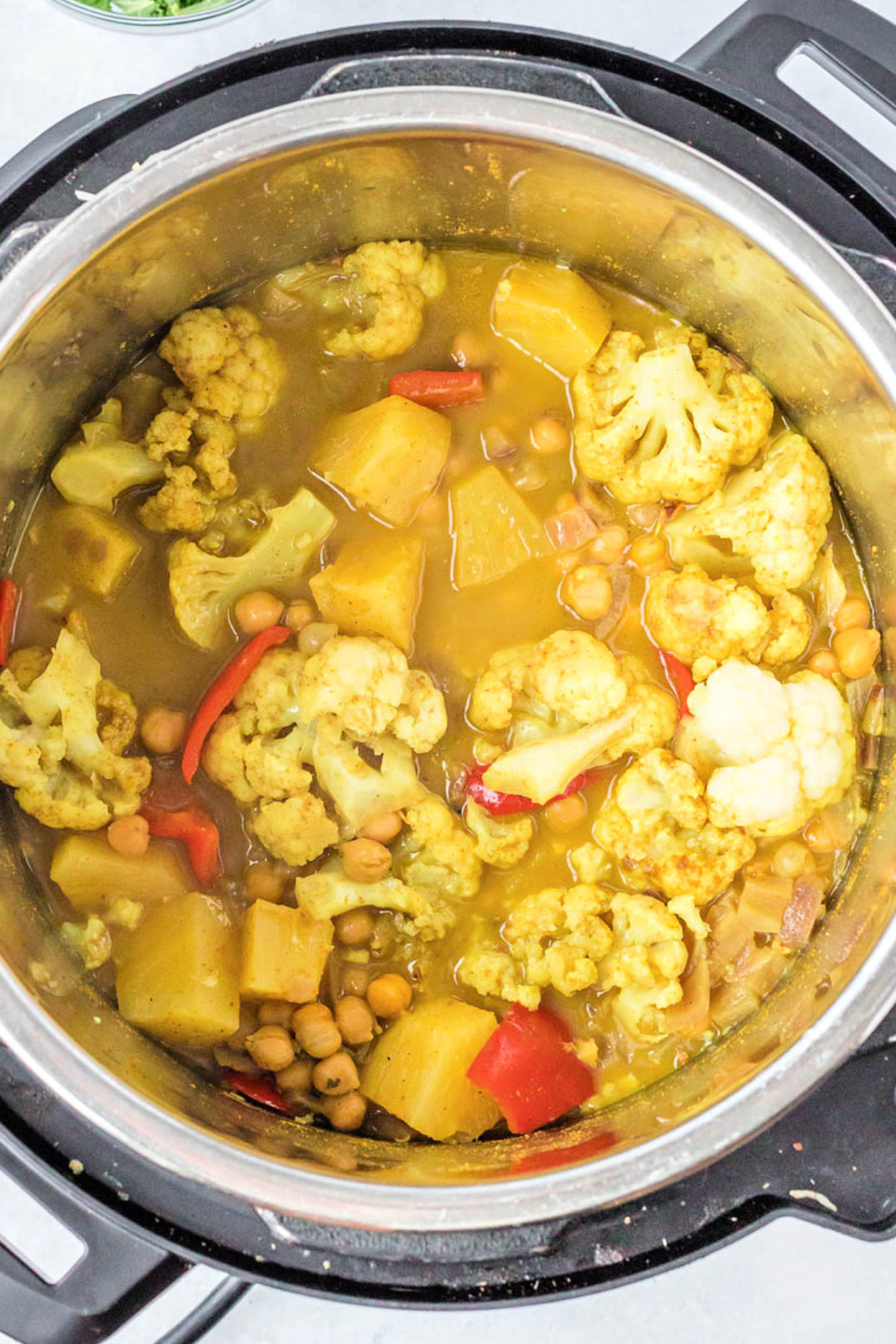 Cooked vegetables in coconut curry in an Instant Pot.