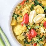 Bowl of chickpea curry with cauliflower and pineapple.