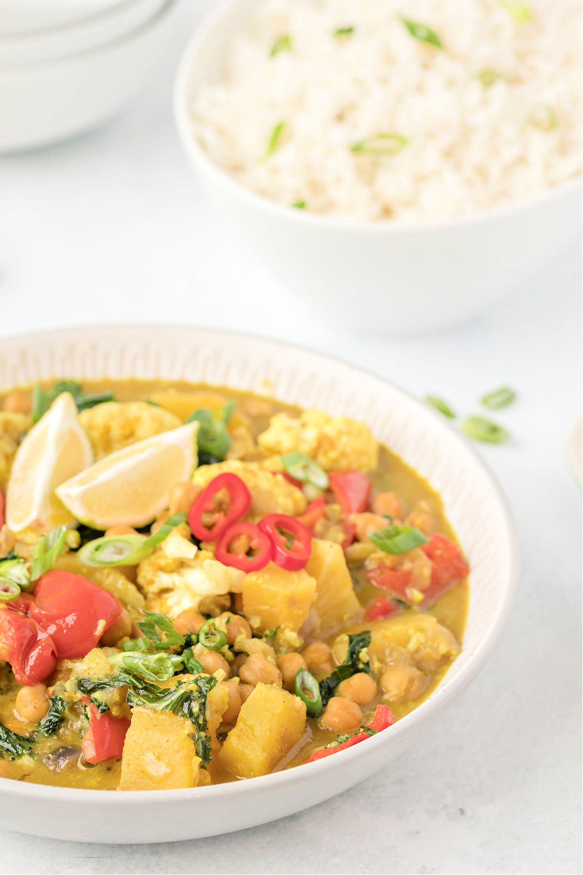 Bowl of chickpea curry and a bowl of rice.
