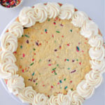 Frosting piped on edge of cookie cake.