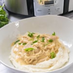 Bowl of chicken and gravy over mashed potatoes.