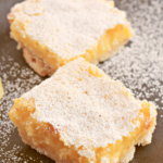 Lemon bars dusted with powdered sugar.