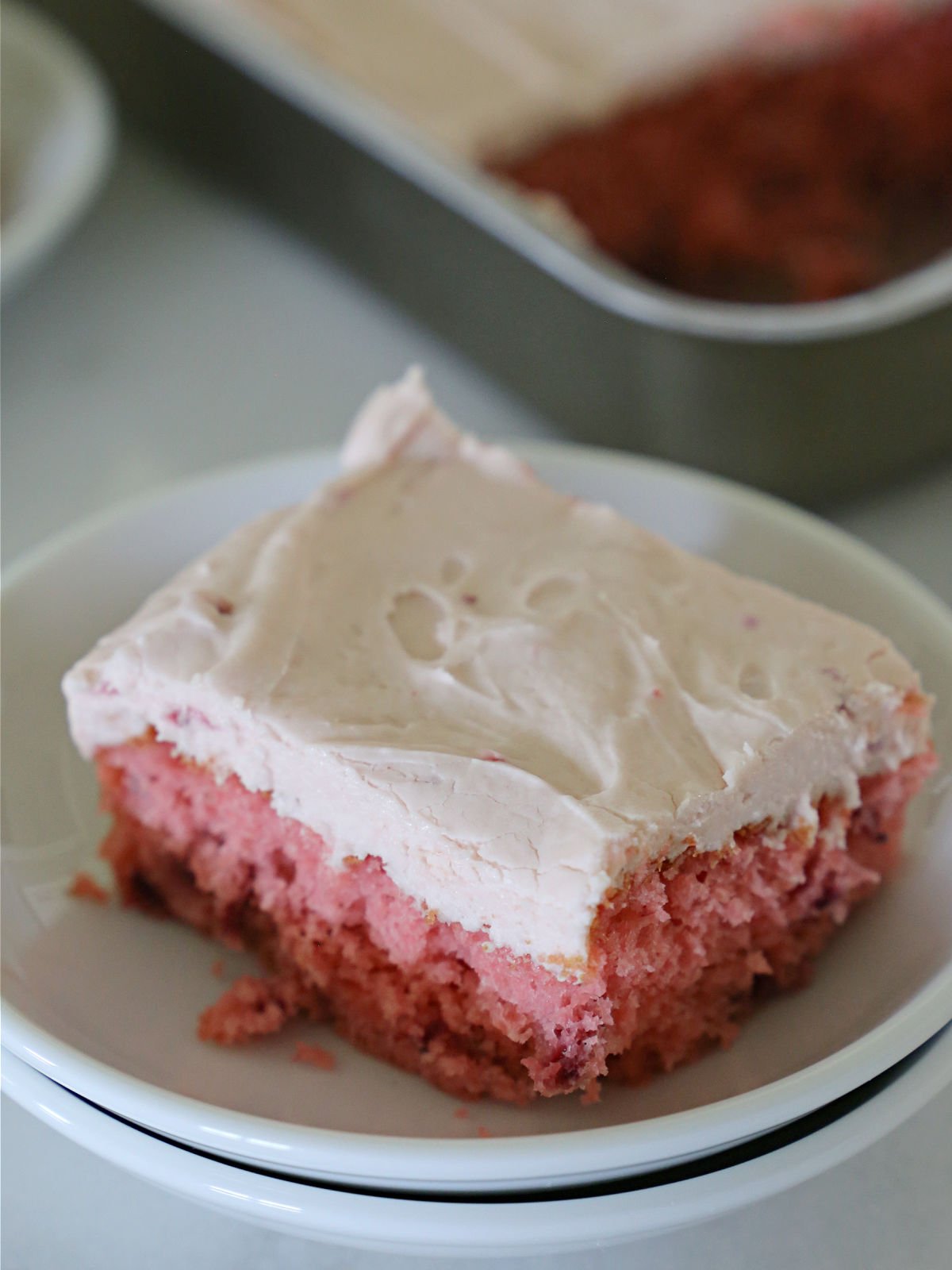 Easy Strawberry Cake Slice of strawberry cake topped with strawberry frosting.