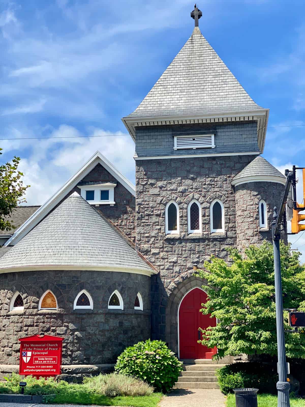 Old Episcopal church with red doors.