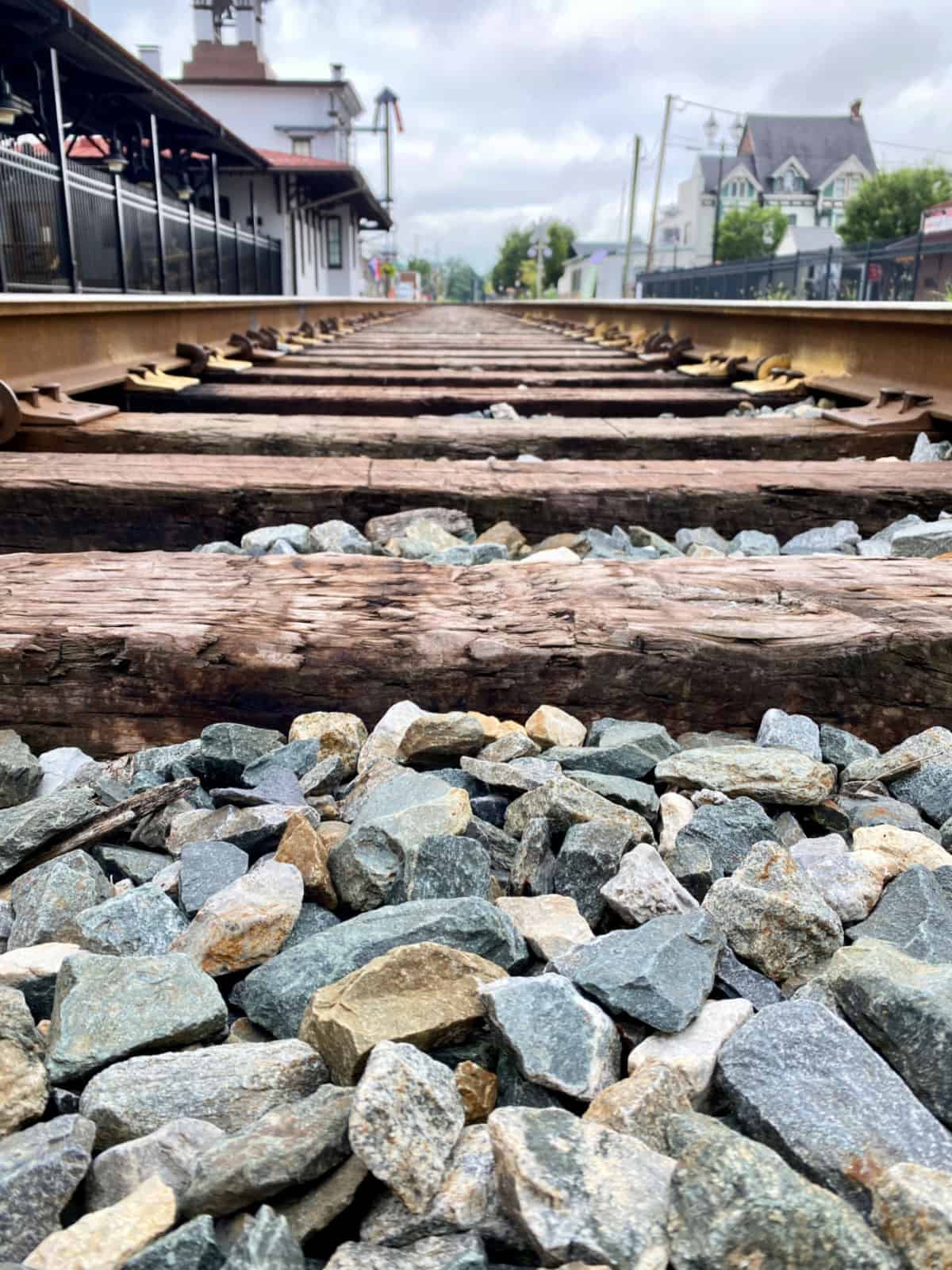 Rocks in between railroad tracks.