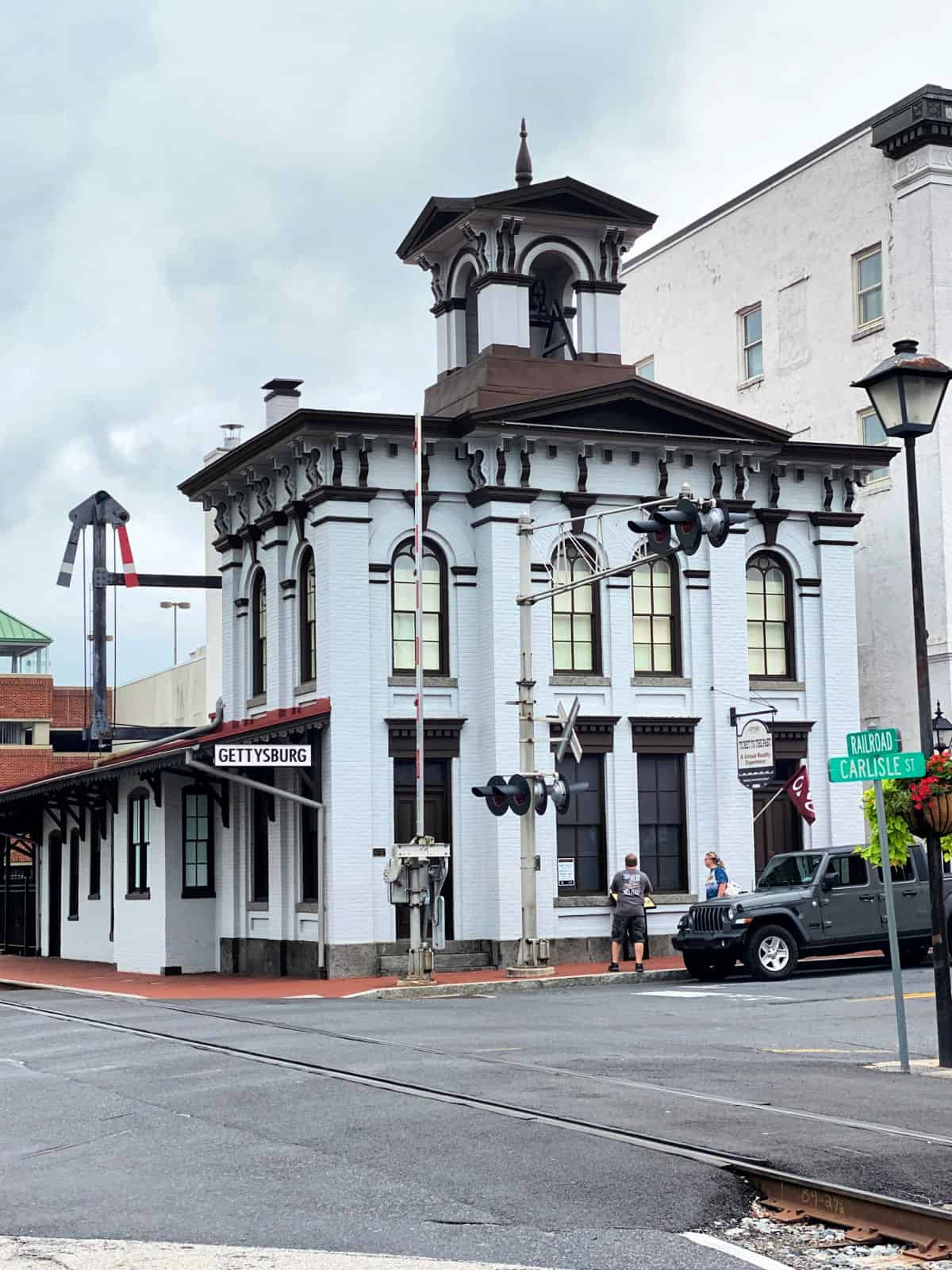 Two story white train station.
