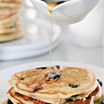 Blueberry pancakes and syrup.