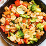 Skillet of garlic butter shrimp and vegetables.