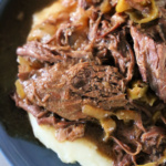 Plate with mashed potatoes topped with Mississippi Pot Roast.