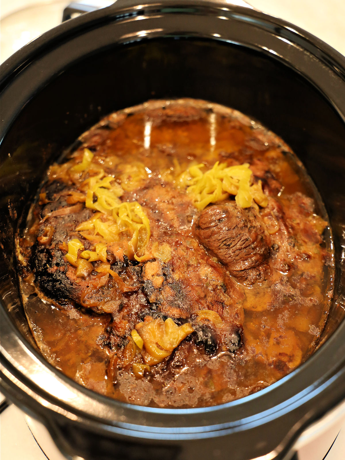 Cooked pot roast in a Crockpot.