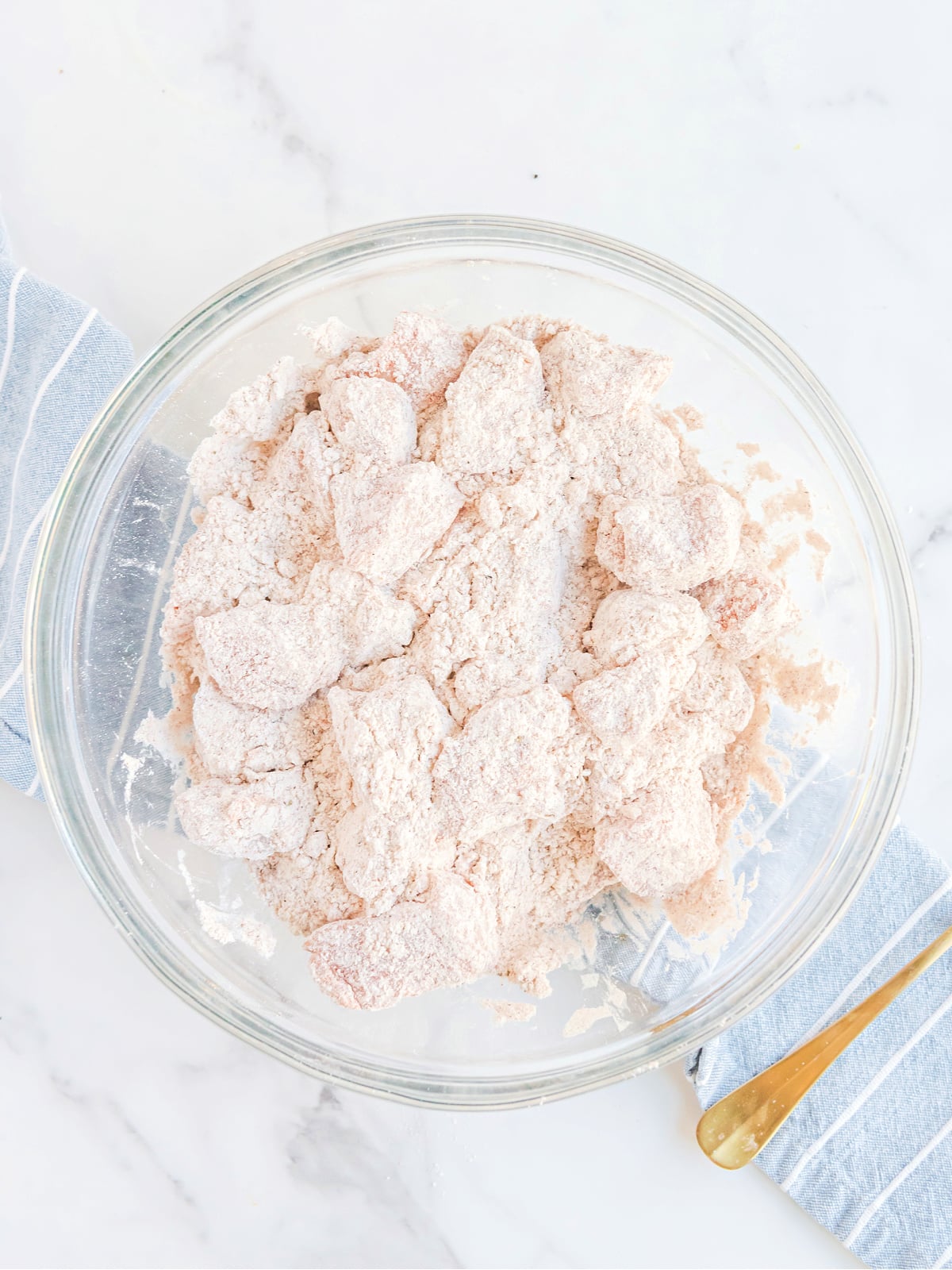 Breaded chicken in a glass bowl.