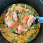 Bowl of soup with chicken, bacon, and spinach.