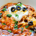 Bowl of chicken enchilada casserole.