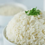 Rice topped with parsley in a bowl.