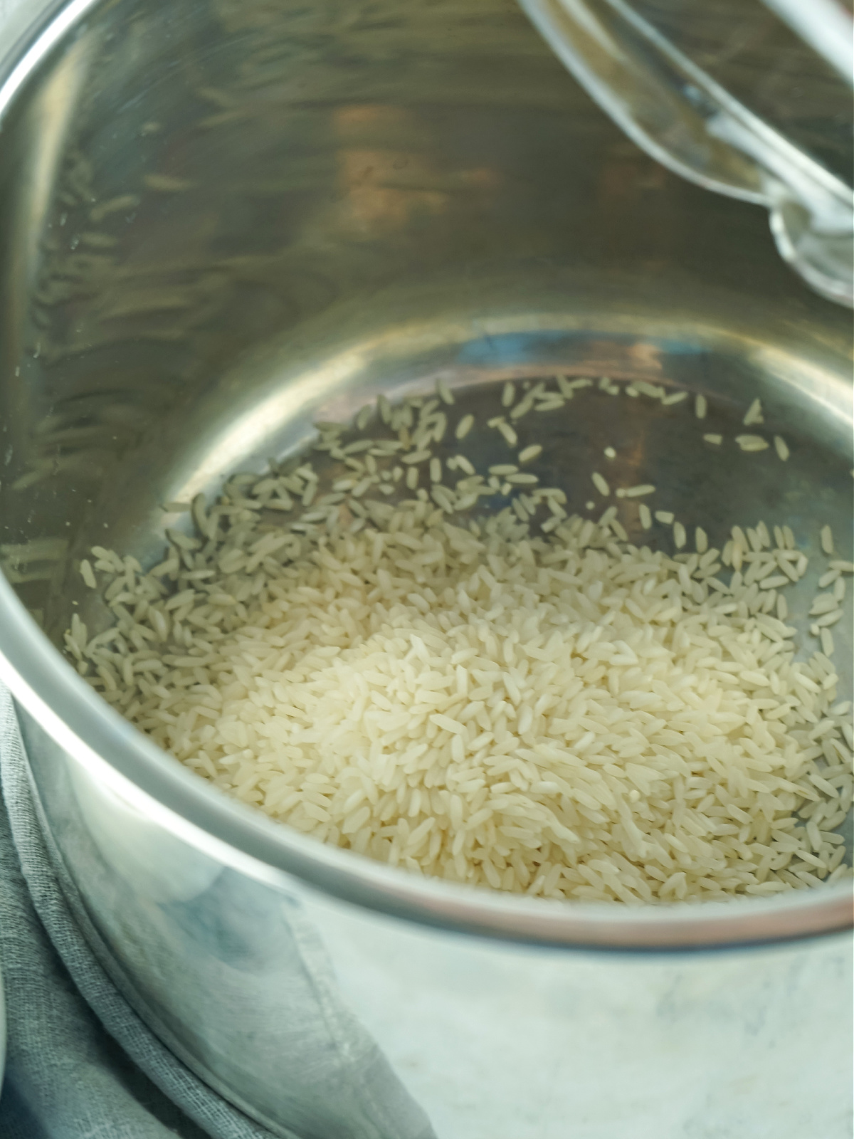 Rice in the bowl of a pressure cooker.