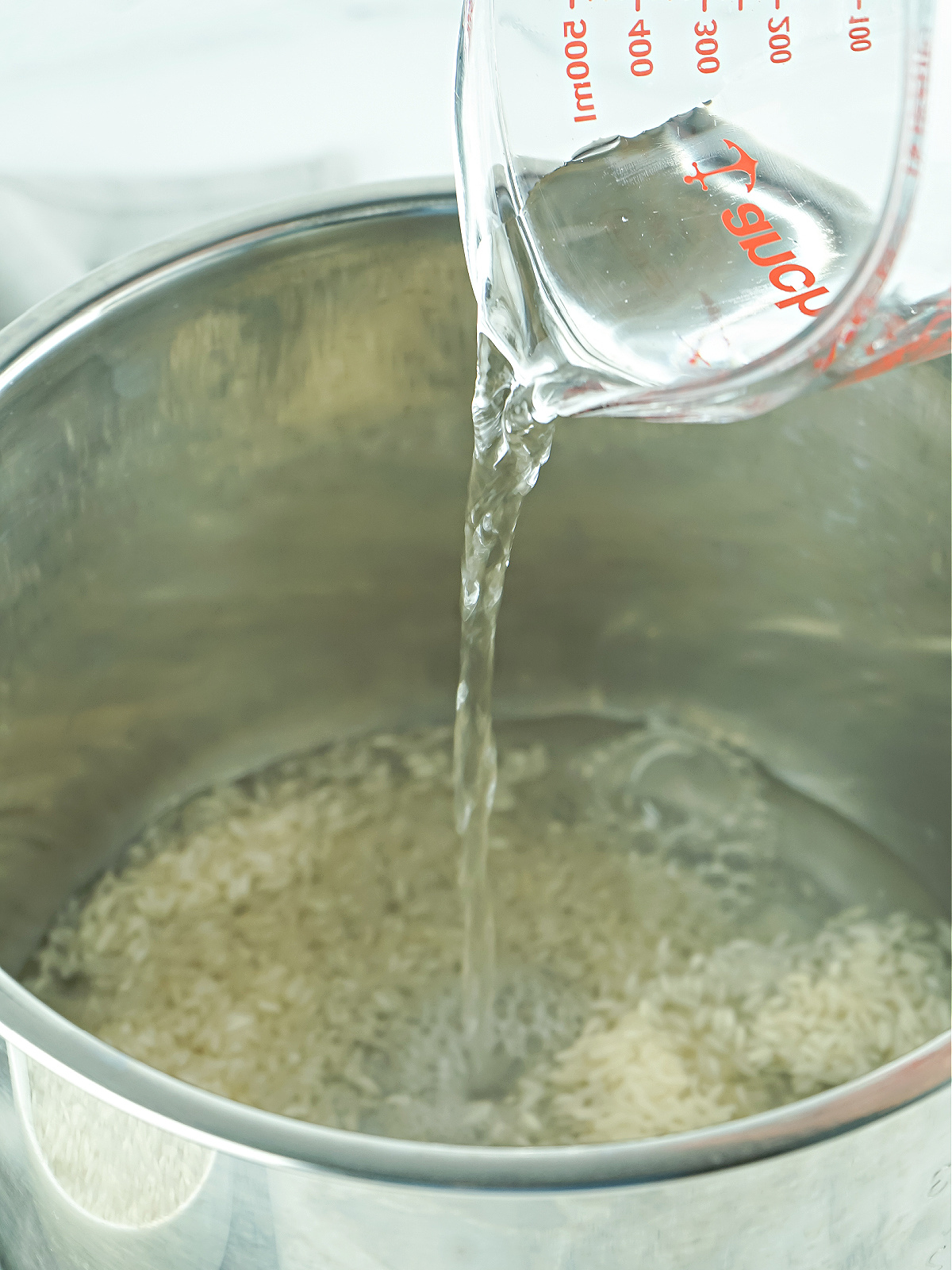 Water being poured into an Instant Pot.