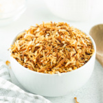 Bowl of toasted coconut.
