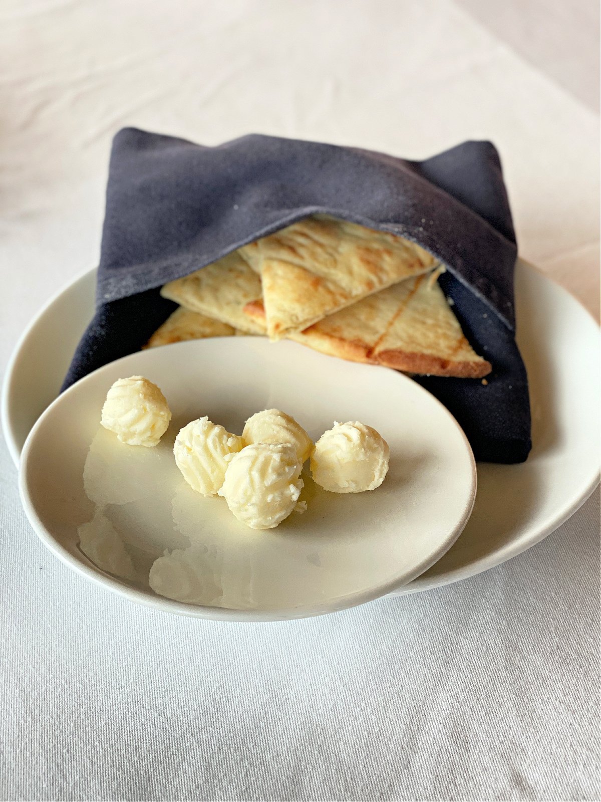 Flat bread wedges and butter.