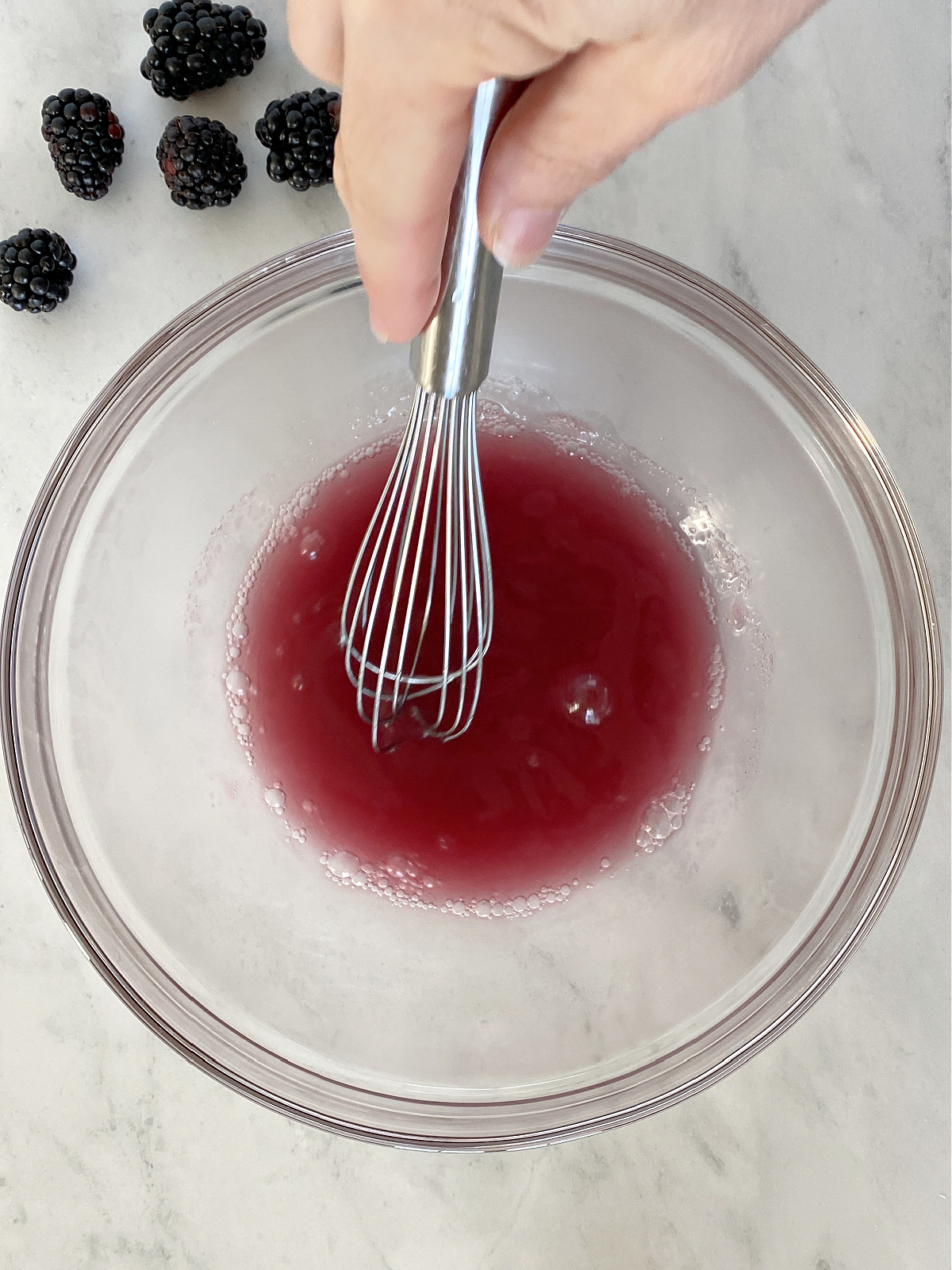 Gelatin being whisked into juice.