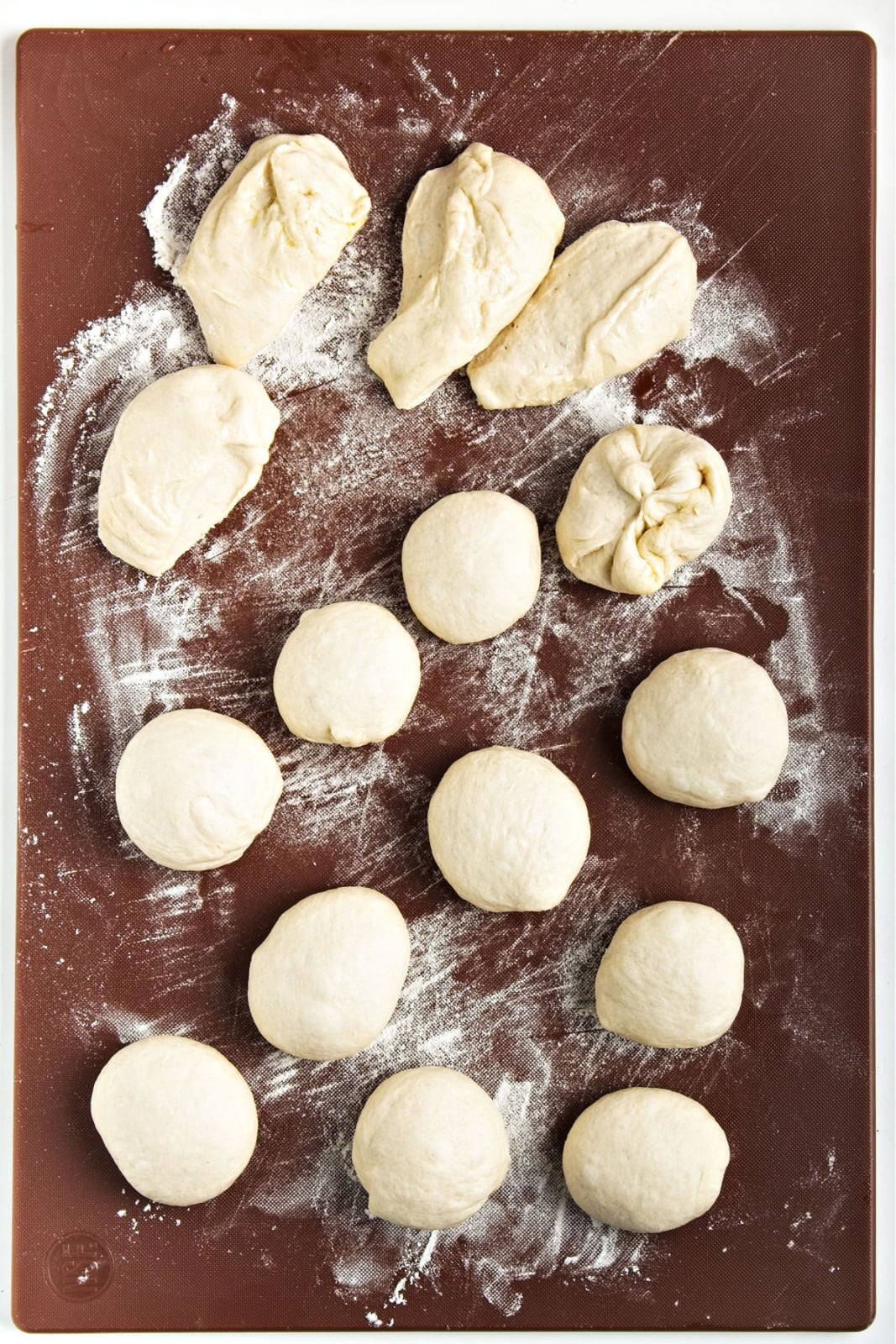 Dough being formed into small balls.