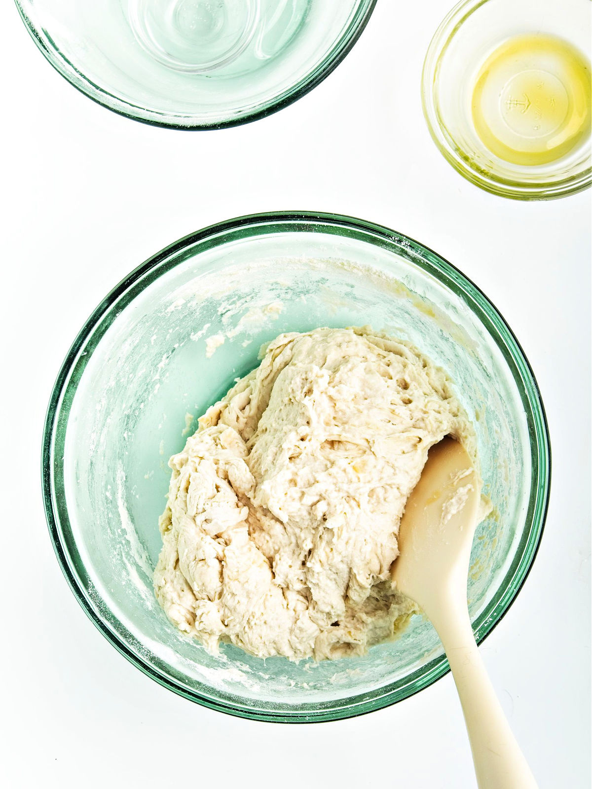 Dough being mixed in a bowl.
