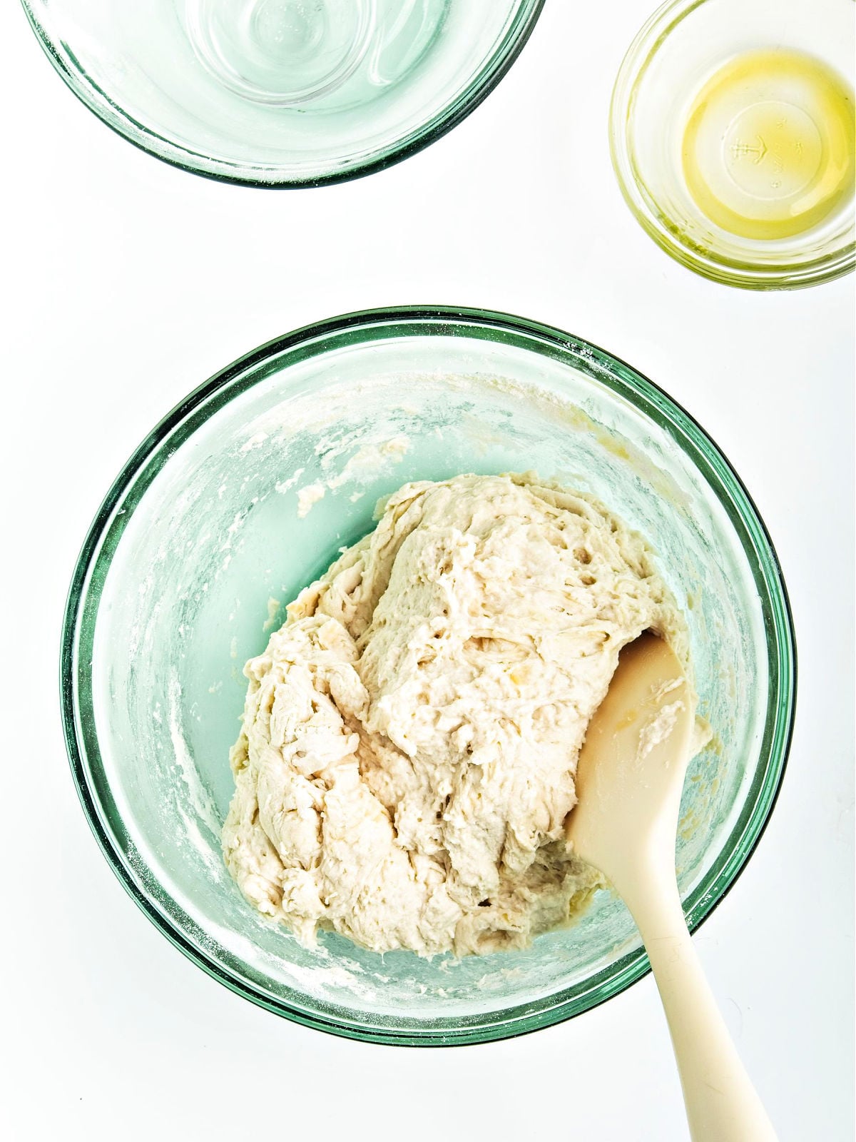 Dough being mixed in a bowl.