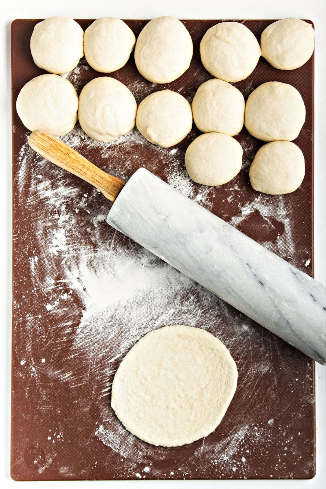 PIta bread rounds being rolled out.