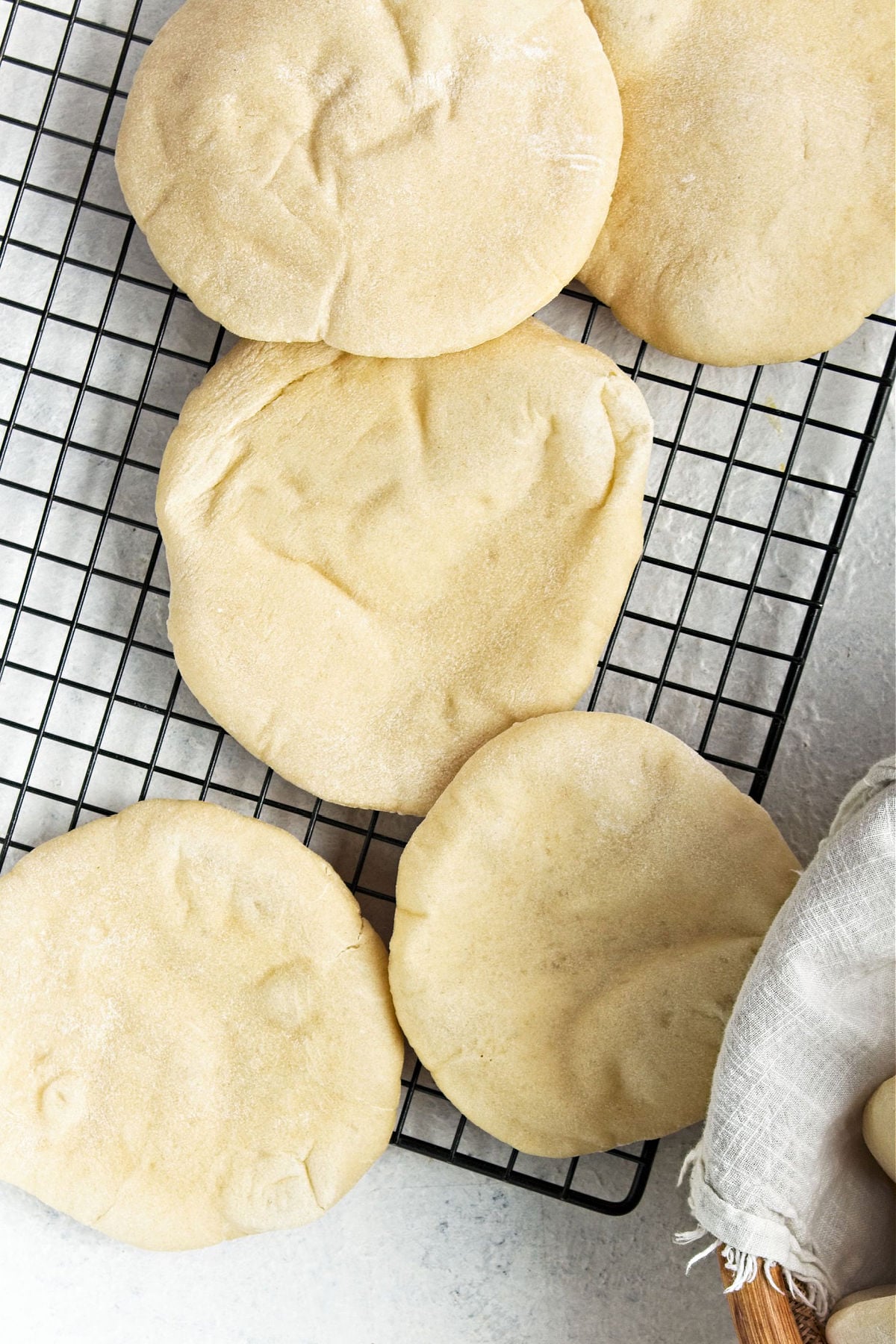 Pita bread on a wire rack.