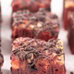 Red velvet brownies with Oreo cookies drizzled with chocolate.