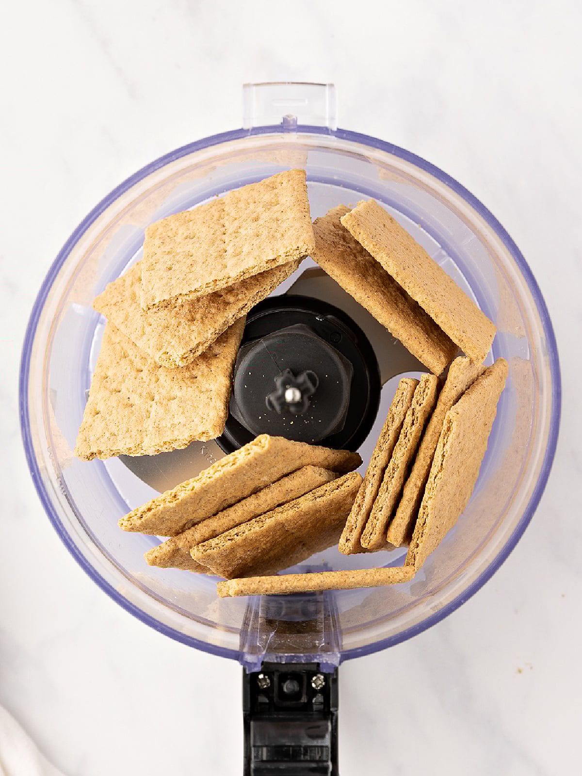 Graham crackers in a food processor before being processed.