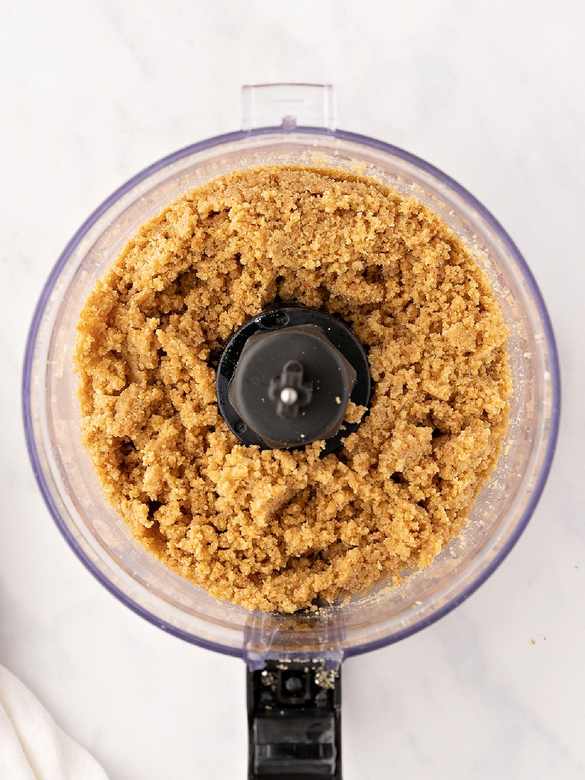 Graham cracker crumbs and butter in a food processor.