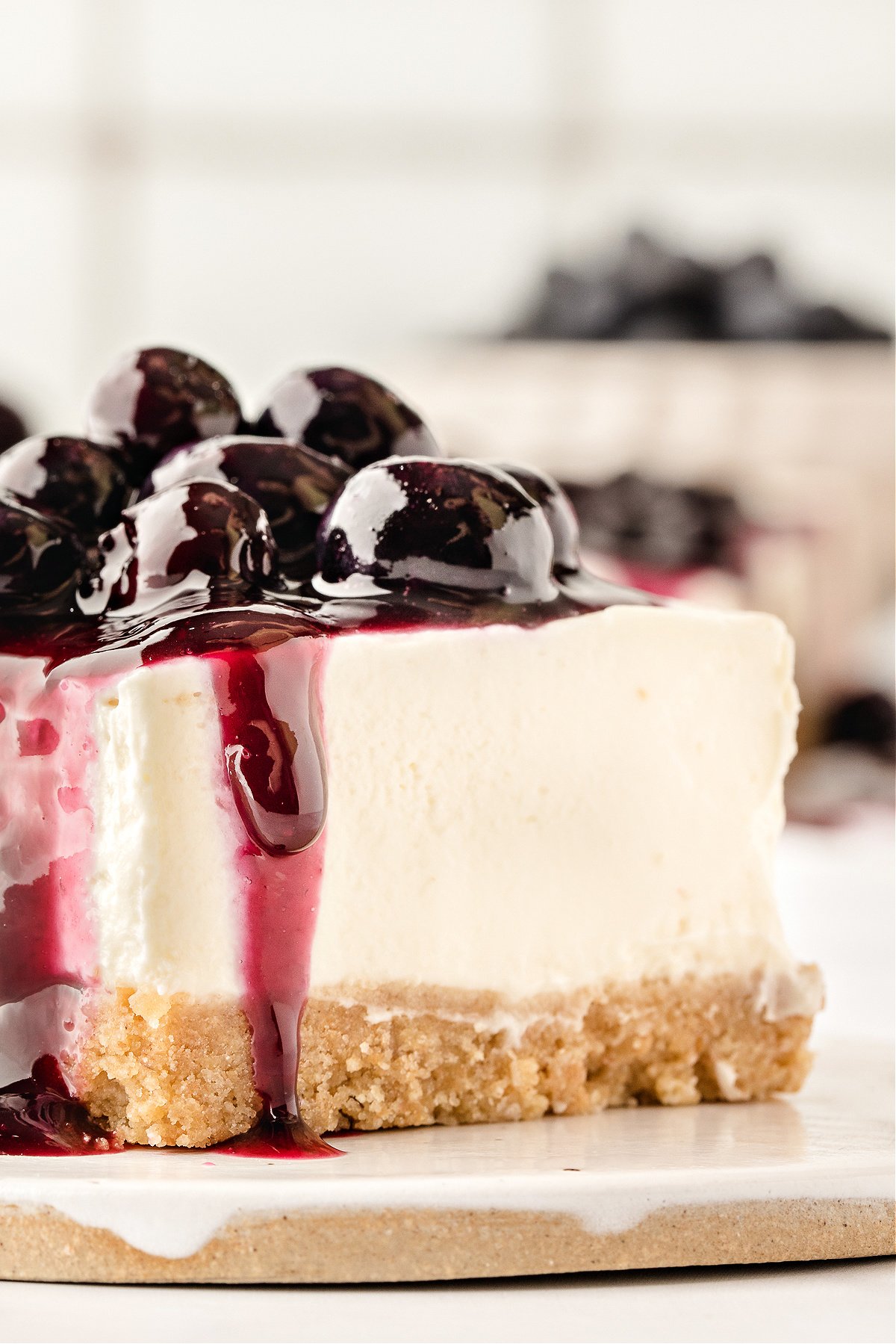 Slice of no-bake cheesecake topped with blueberry sauce.