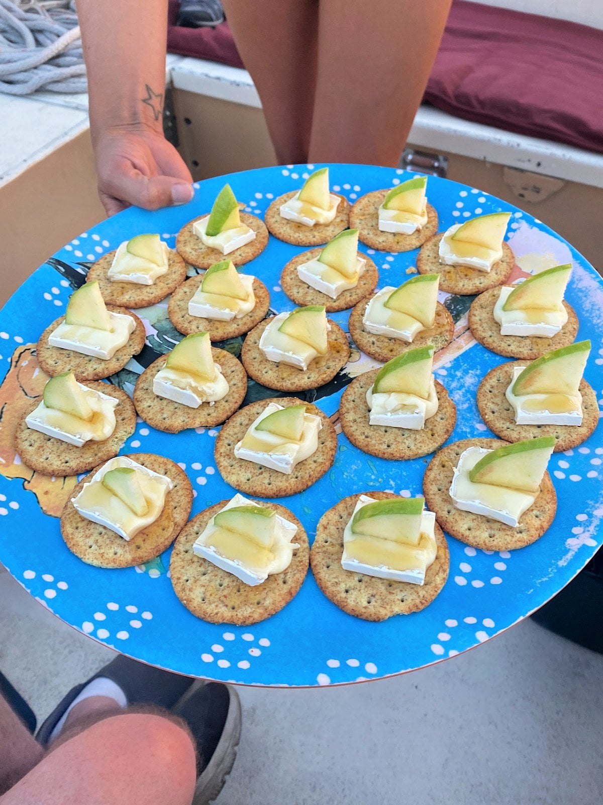 Crackers topped with brie cheese and apple slices.
