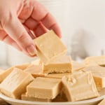 Lady's hand picking up a piece of peanut butter fudge.