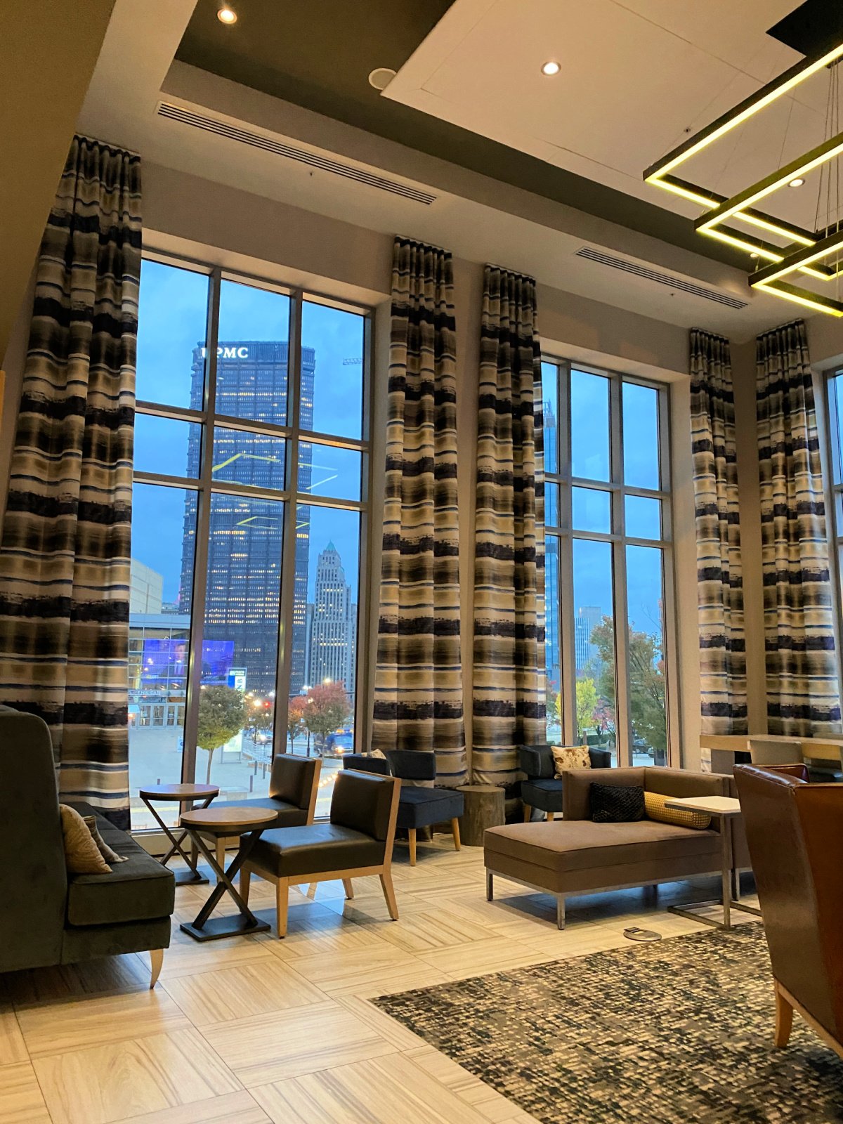 Lobby with tall ceilings and views of Pittsburgh.