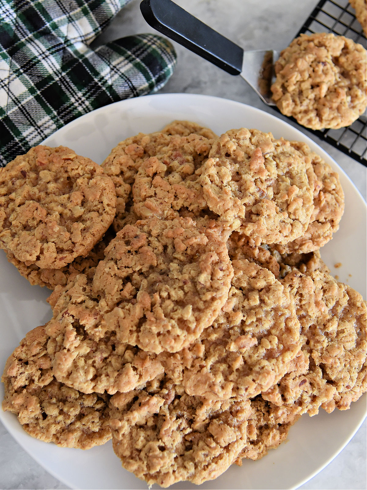 Pecan cookies being placed on a plate.