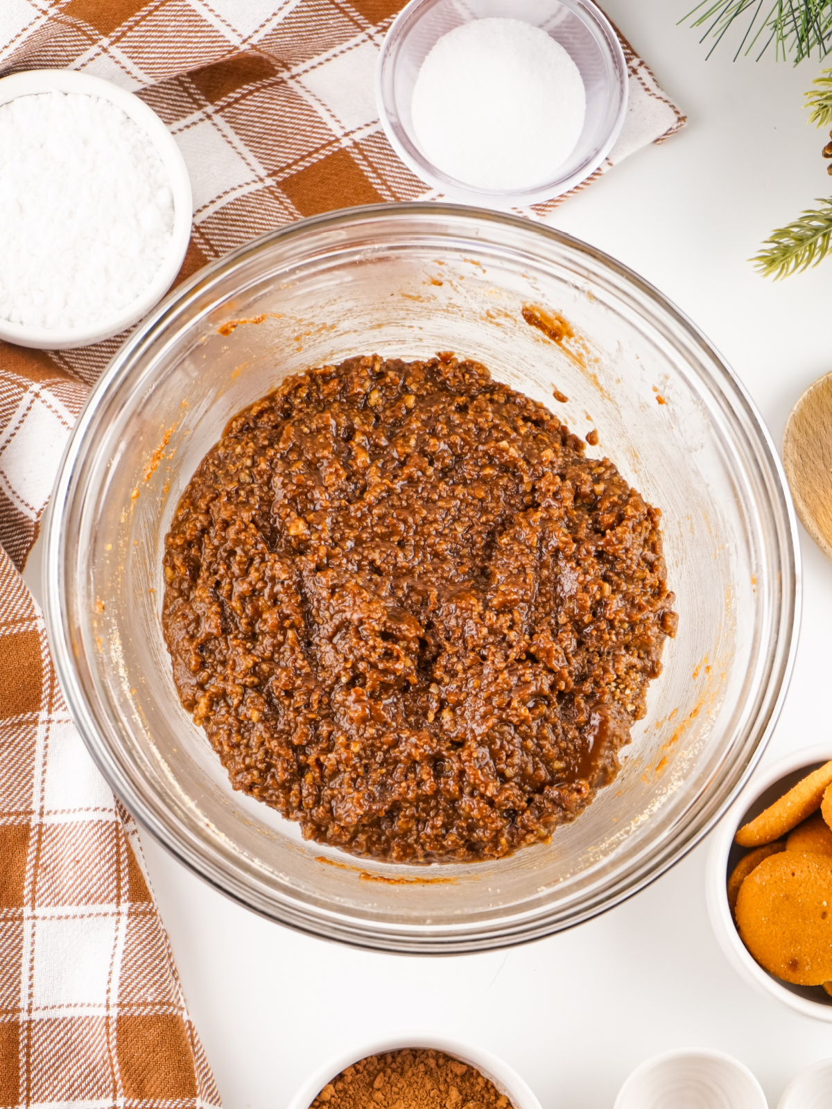 Rum ball ingredients mixed together in a glass mixing bowl.