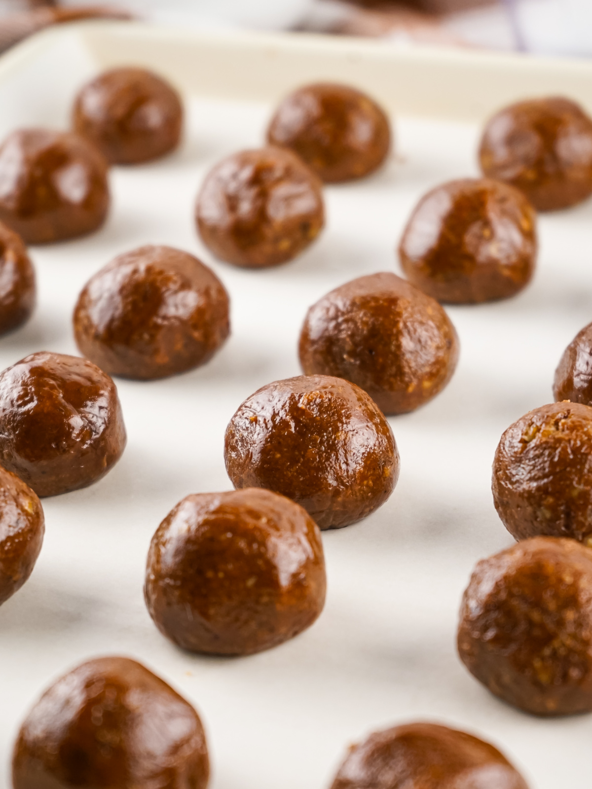 Rum balls on parchment paper.