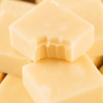 Piece of vanilla fudge with a bite taken out of it.