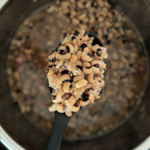 Scoop of cooked black-eyed peas.
