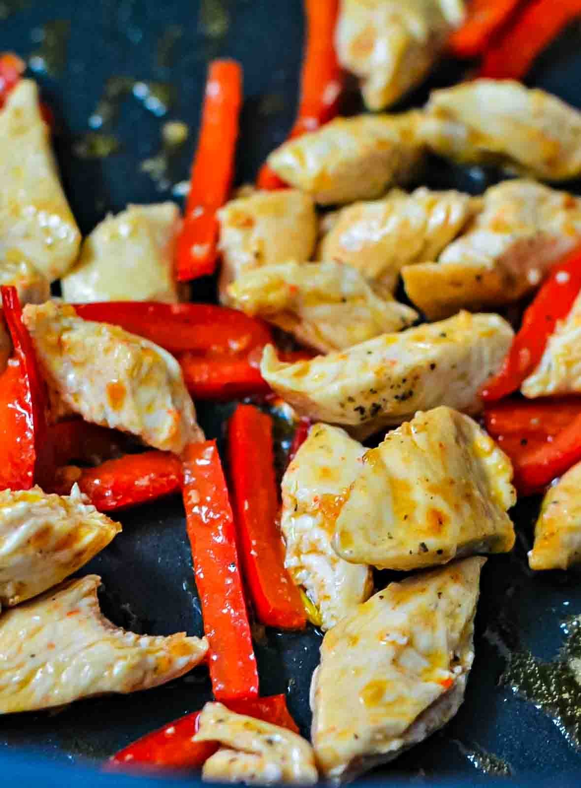 Honey Garlic Chicken - one of my favorite recipes for a delicious, healthy dinner - or lunch! Chicken and bell peppers cooking in a nonstick skillet.