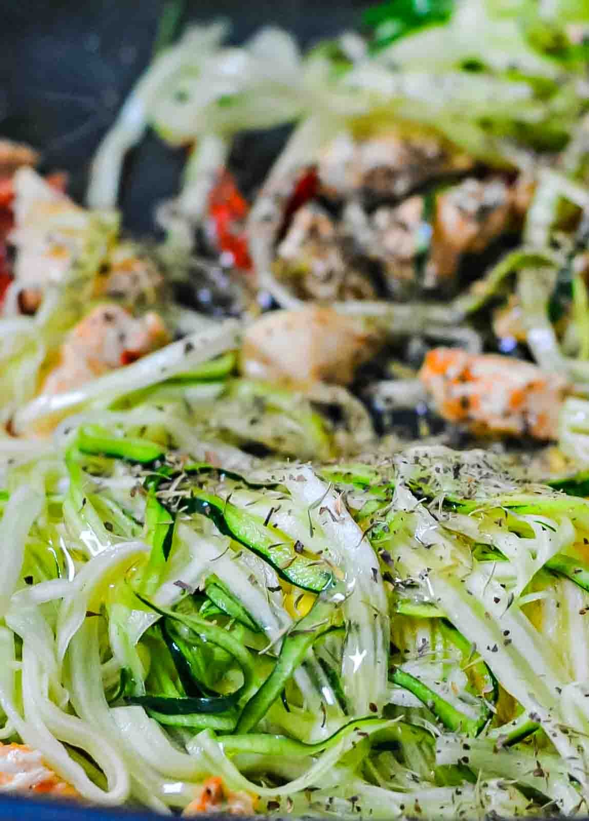 Honey Garlic Chicken - one of my favorite recipes for a delicious, healthy dinner - or lunch! Zucchini noodles, peppers, and chicken in a skillet.