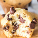 Close-up view of a chocolate chip muffin that had a bite taken out of it.