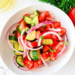Bowl of tomato cucumber salad.