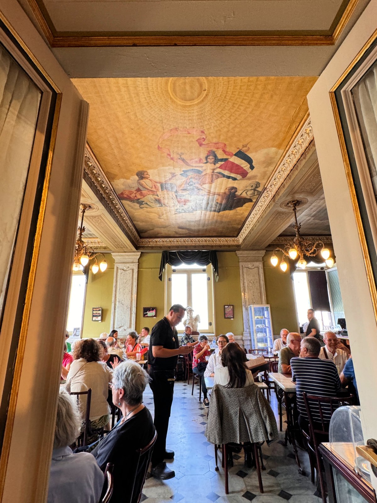 People dining in a restaurant inside of the National Theater.