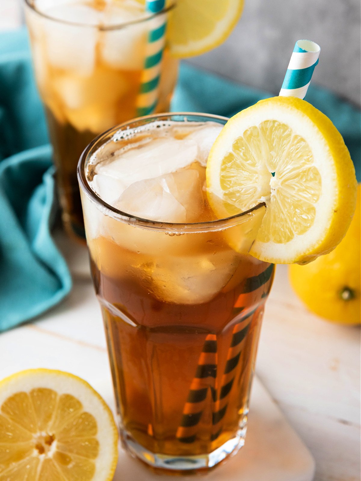 Glass of sweet tea garnished with a lemon wedge.