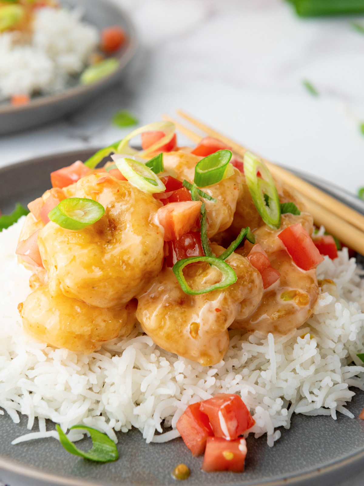 Close up of bang bang shrimp served over rice.