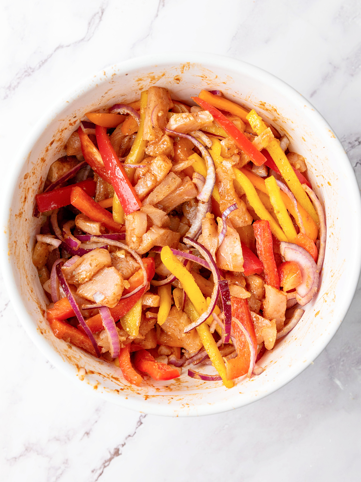 Seasoned chicken and vegetables in a bowl.